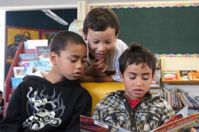 Students looking at a book together.